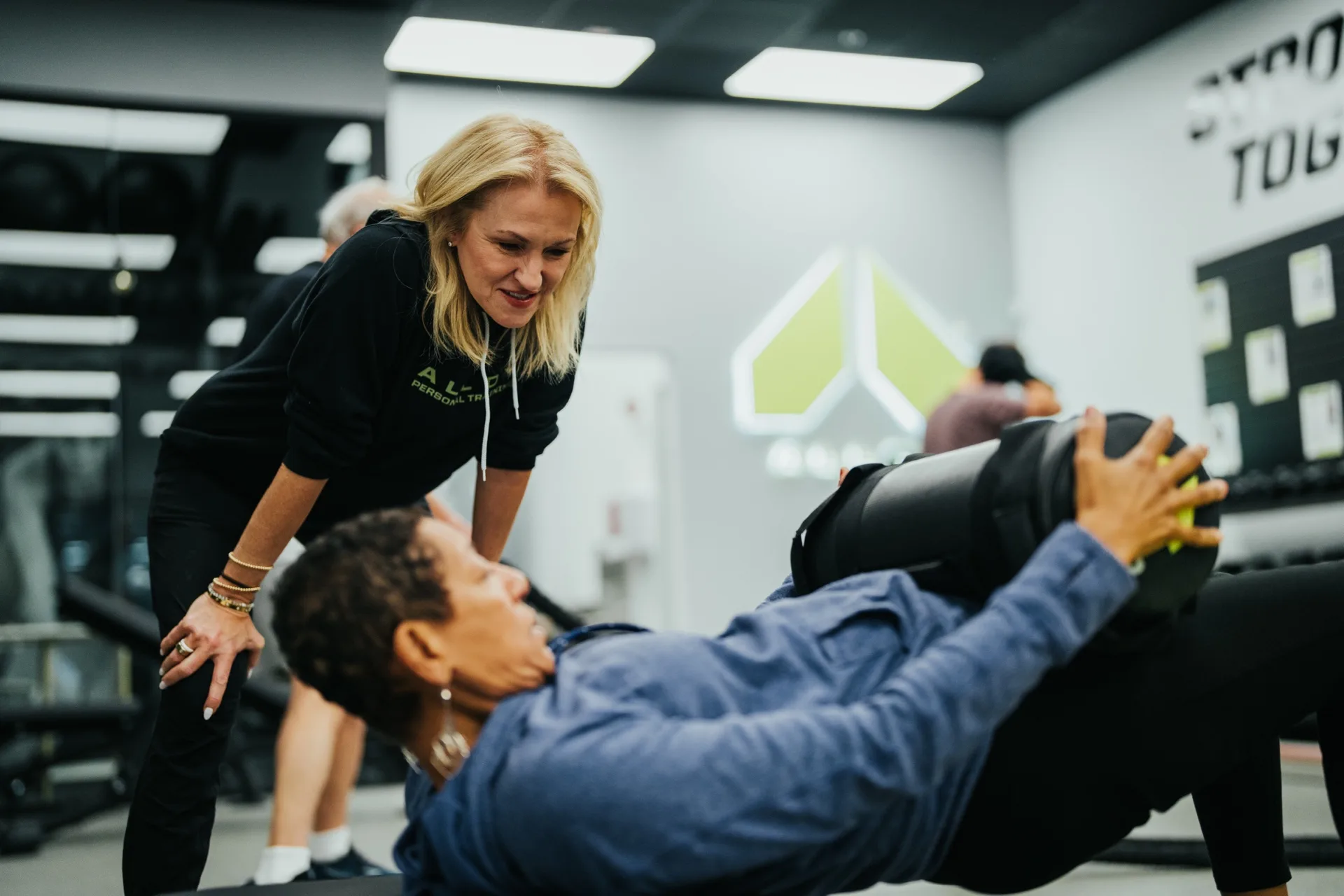 Coach guiding a new member through a Starting Point Session at Alloy Personal Training Tanque Verde